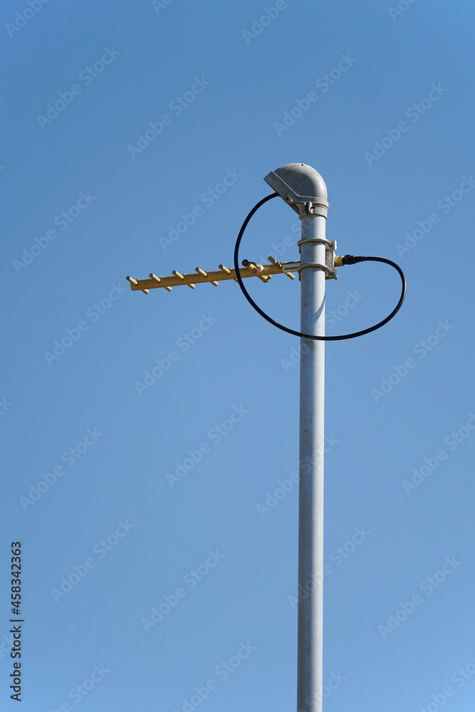 UHF radio antenna on pole against blue sky portrait format UHF radio antenna on pole against blue sky portrait format