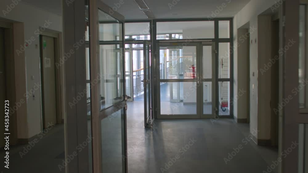 Camera movement along the glass corridor of the building. Interchange of pedestrian doors in the building. Direction of movement. Camera movement along the glass corridor of the building. Interchange of pedestrian doors in the building. Direction of movement.