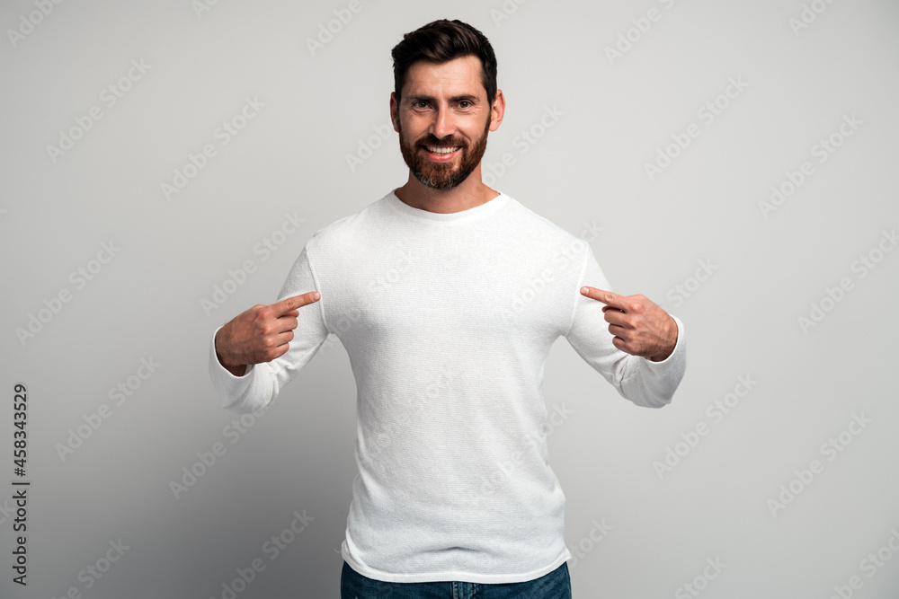 This is me. Portrait of conceited man in white shirt pointing at himself and looking with arrogant selfish expression, feeling successful and self - important. This is me. Portrait of conceited man in white shirt pointing at himself and looking with arrogant selfish expression, feeling successful and self - important.