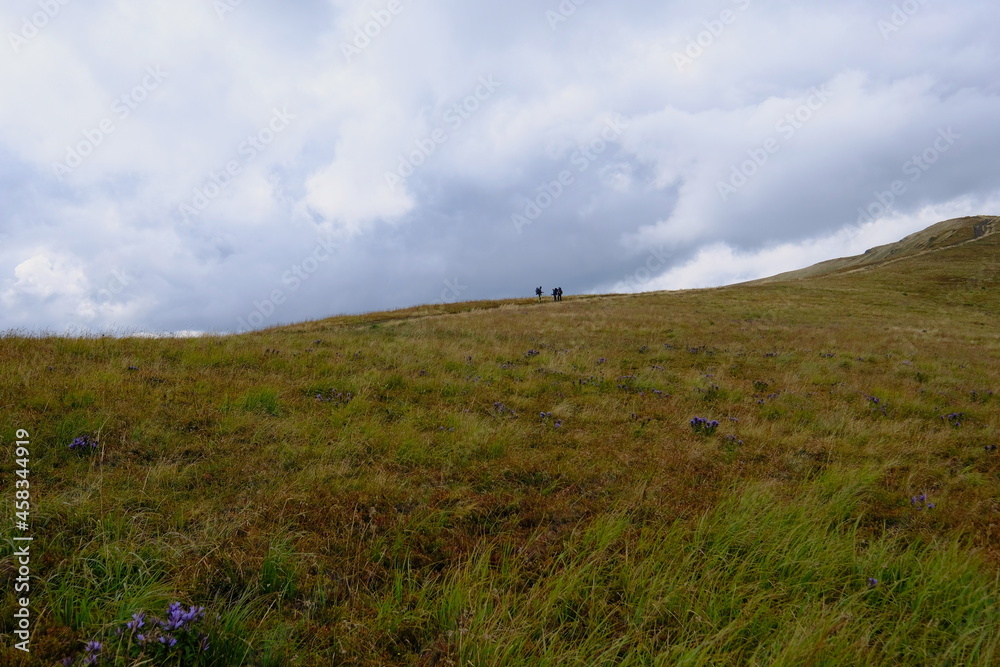 Three hikers on the trail. Ukraine Eastern Bieszczady Carpathians.