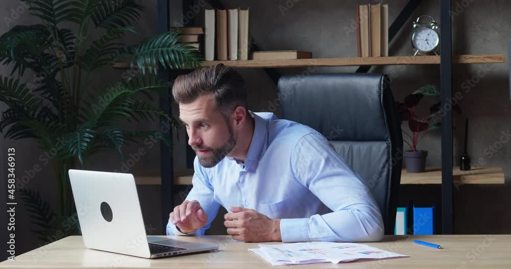 Excited business man checking email reading great news on laptop. Amazed male professional winner feeling happy receiving new job opportunity, reward bonus, celebrates financial market growth concept. Excited business man checking email reading great news on laptop. Amazed male professional winner feeling happy receiving new job opportunity, reward bonus, celebrates financial market growth concept.