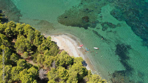 Aerial drone photo of famous bay and small traditional village of Atsitsa covered in pine trees and natural sandy beaches  Skiros island  Sporades  Greece