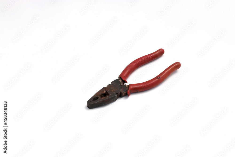 Old used rusty pliers with red grip isolated on white background. Old used rusty pliers with red grip isolated on white background.