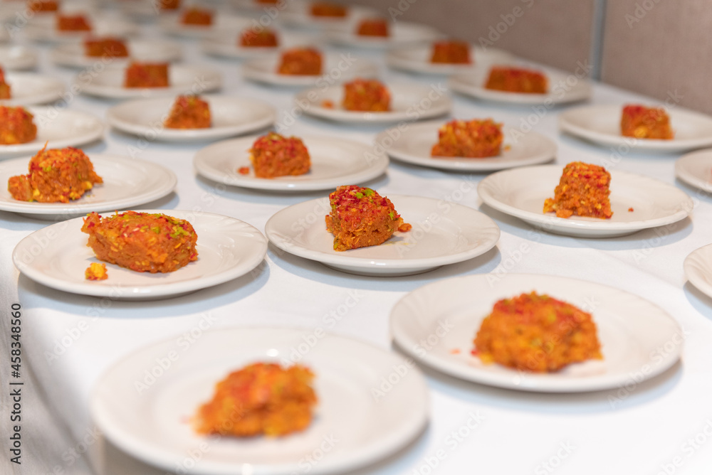 Small saucers of Halwa cake desserts served to guests at traditional Indian party ceremony. Small saucers of Halwa cake desserts served to guests at traditional Indian party ceremony.