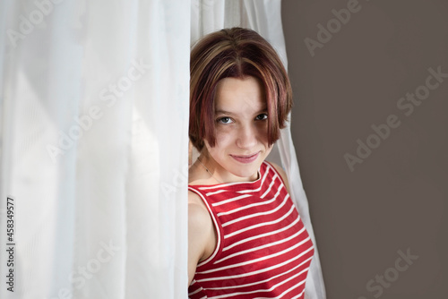 Portrait of a 13-14-year-old girl with short colored hair, the girl smiles and is happy that she is healthy, because she was ill for a long time and could not study
