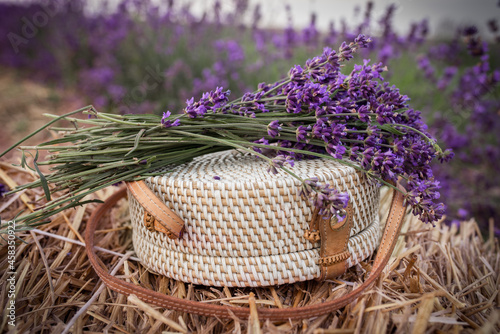 round wicker handbag and lavender bouquet