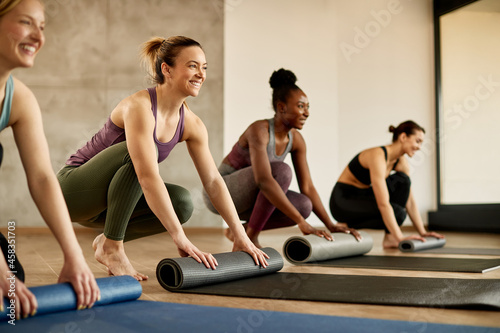 Happy female athletes have group training at exercise club.