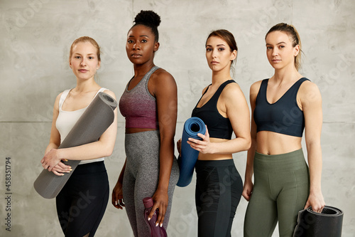 Portrait of multi-ethnic group of athletic women looking at camera. photo