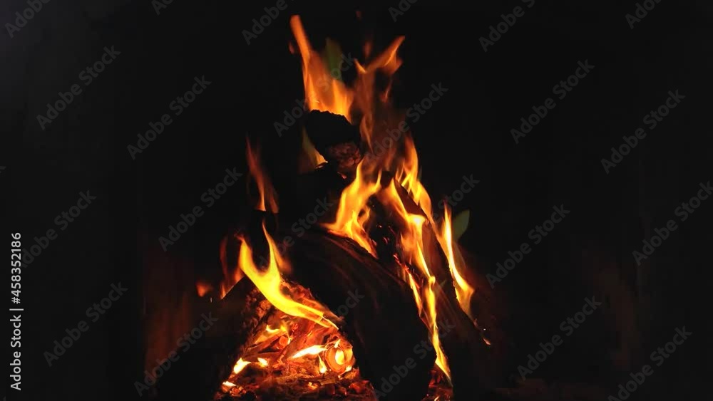 Timelapse of a bonfire in the fireplace. Burning pine logs close-up in flames. Fire background. A beautiful fire burns brightly. Flames rise upward. Timelapse of a bonfire in the fireplace. Burning pine logs close-up in flames. Fire background. A beautiful fire burns brightly. Flames rise upward.