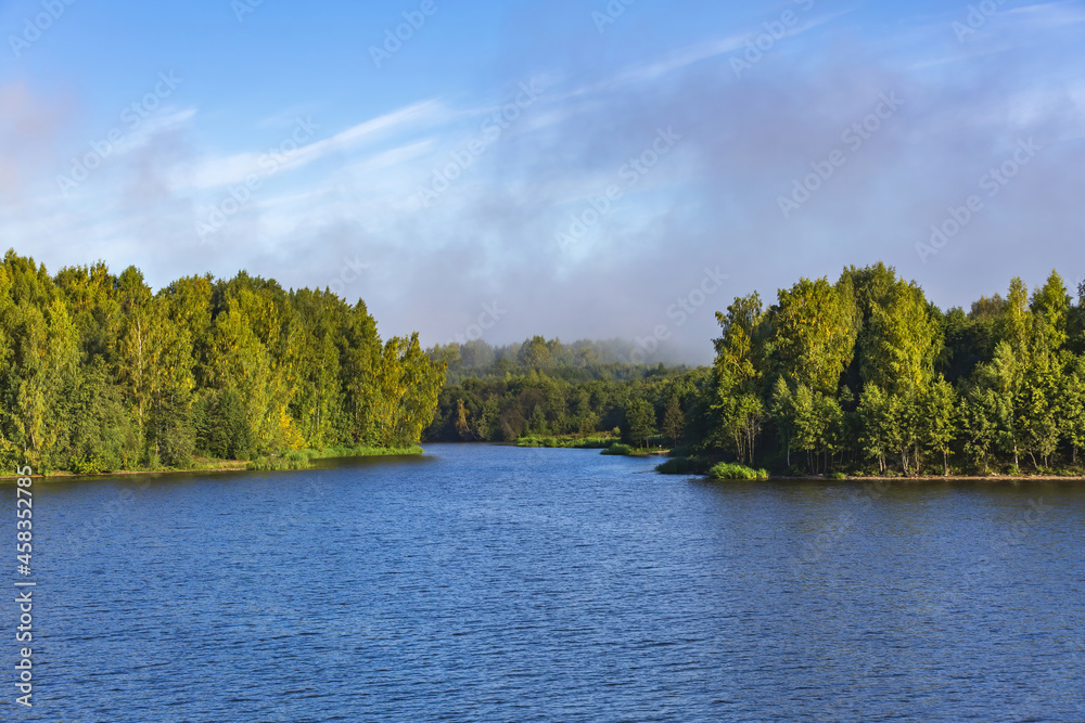 Scenic river landscape with green trees in early autumn Scenic river landscape with green trees in early autumn