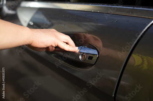 woman hand a car door close up
