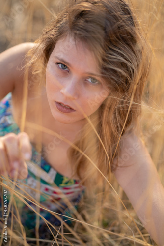 Natural Looking Young Beautiful Woman with Hazel eyes posing in the fields, no post editing