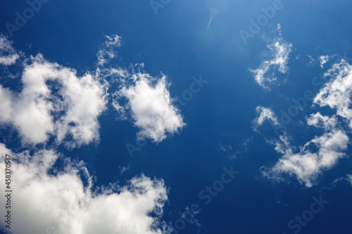 Blue sky with white soft clouds. Summer landscape with fluffy cloud