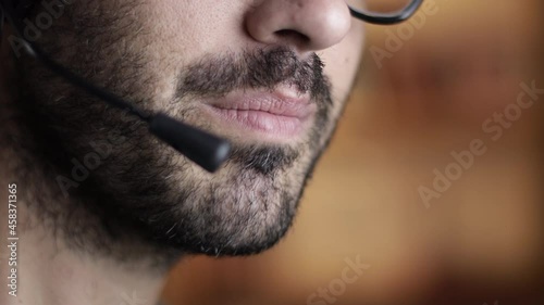 Call center operator with headset, closeup of mouth, shallow depth of field