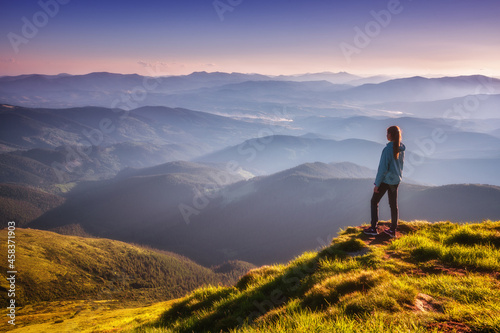 Girl on mountain peak with ...