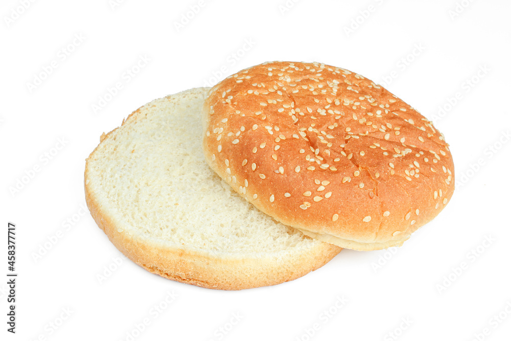 Two parts of sliced burger bun with sesame isolated on white background