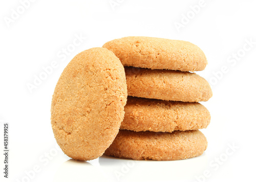 Pile of brown cookies isolated on white background