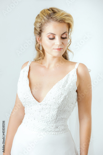 blonde caucasian bride on white dress