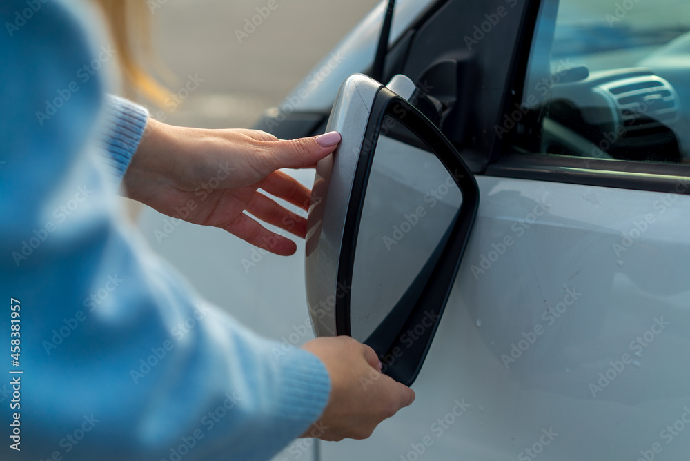Broken off side rearview mirror on car. Woman is checking for damage on her auto Broken off side rearview mirror on car. Woman is checking for damage on her auto