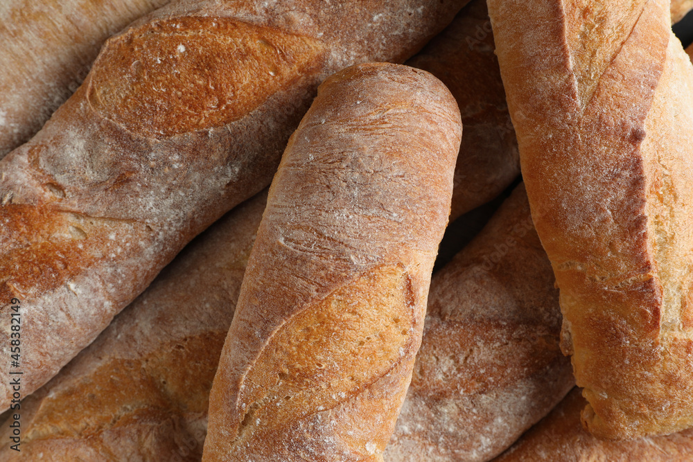 Crispy French baguettes as background, top view. Fresh bread