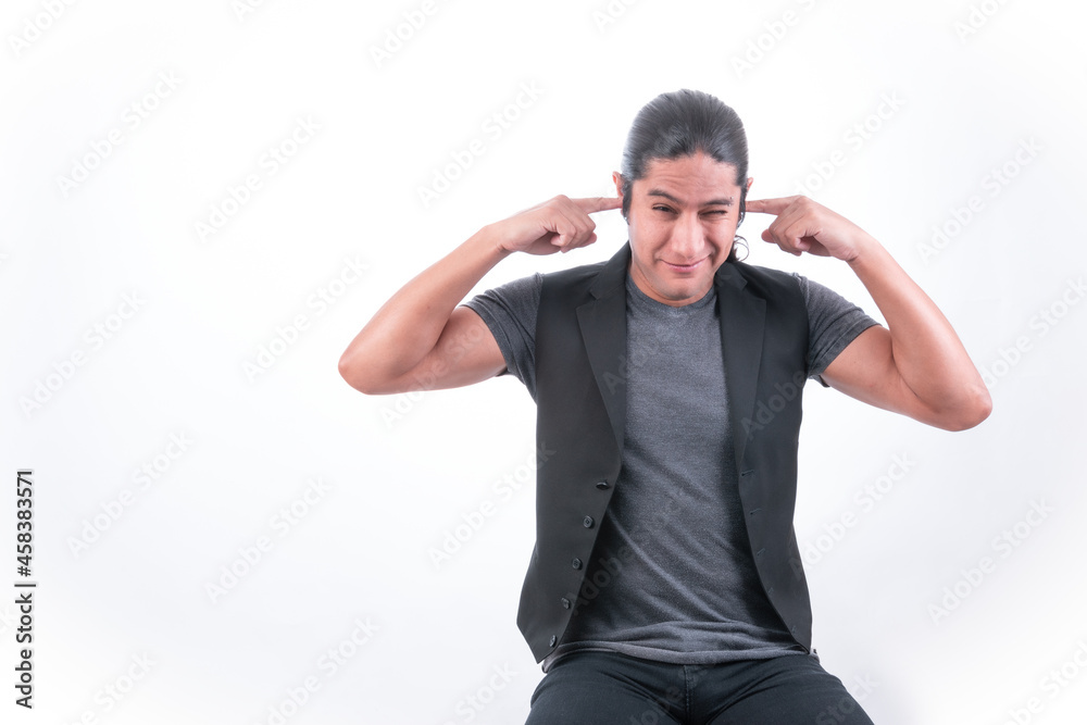 Person with white background, man making gestures, he covers his ears with his fingers, there is a lot of noise and it bothers him, he does not want to hear what they are saying Person with white background, man making gestures, he covers his ears with his fingers, there is a lot of noise and it bothers him, he does not want to hear what they are saying