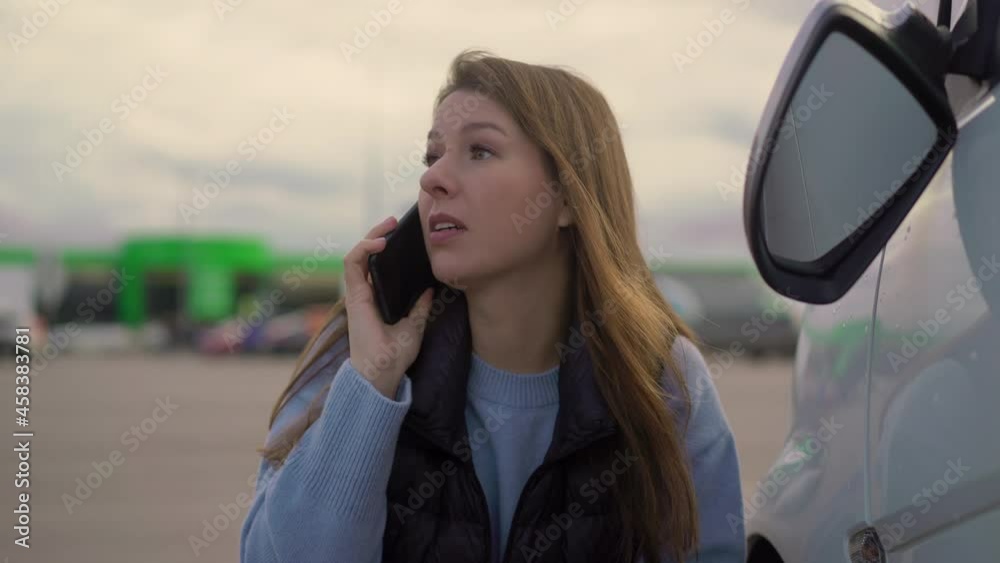 Woman speaks on phone. Traffic accident with car, broken off rear-view mirror. Woman speaks on phone. Traffic accident with car, broken off rear-view mirror.