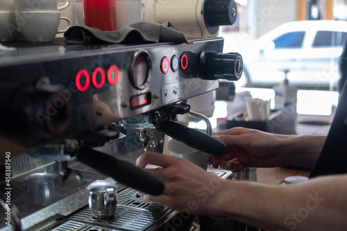 Barista faceless make coffee latte art with espresso machine in cafe 