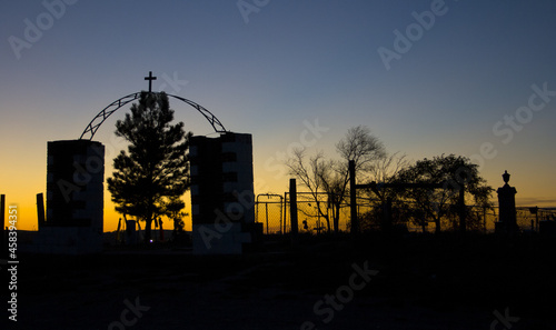 Silhouette of the entrance to the Wounded Knee Massacre Monument in South Dakota at sunrise