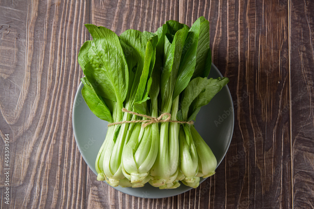 Pak Choi (Bok Choy) or Brassica chinensis green vegetable on wooden background Pak Choi (Bok Choy) or Brassica chinensis green vegetable on wooden background