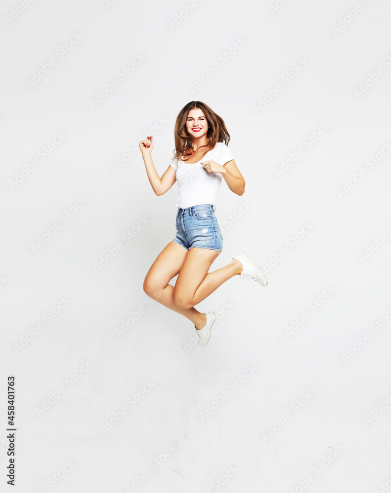 Portrait of active girl in motion jumping over in the air Portrait of active girl in motion jumping over in the air
