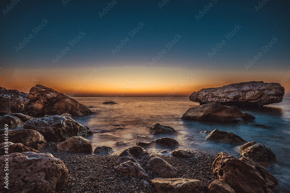 rocky coast of the mediterranean sea at dawn