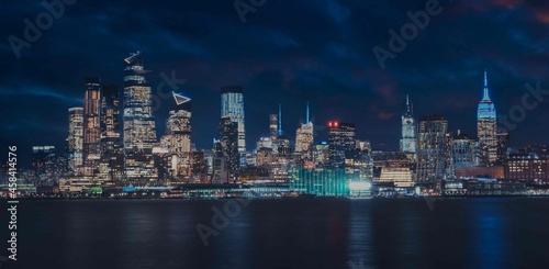 new York city skyline at night beautiful reflections skyscrapers buildings sea 