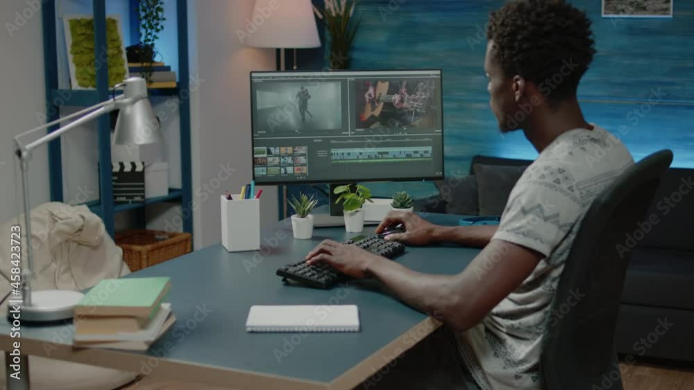 Videographer doing editing work for video montage on computer. Film maker working with footage and professional software on monitor for production. Media designer using visual effects