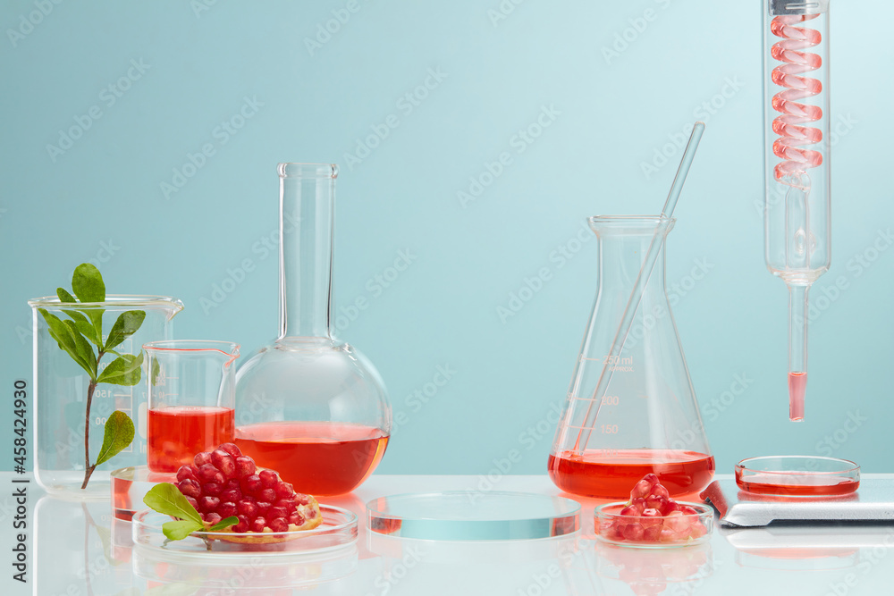 Empty podium glass with pomegranate extract. science laboratory test tubes, chemical laboratory equipment. Research and develop cosmetic in lab with pomegranate extract . 