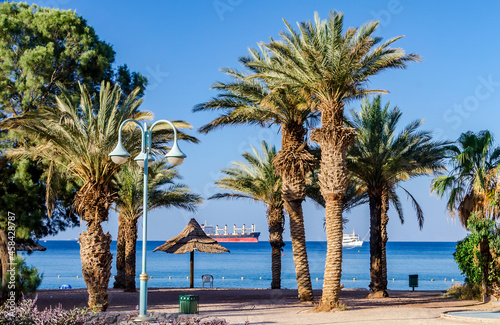 Sandy beach and relaxing atmosphere at central public beach in Eilat - famous tourist resort and recreational city in Israel 