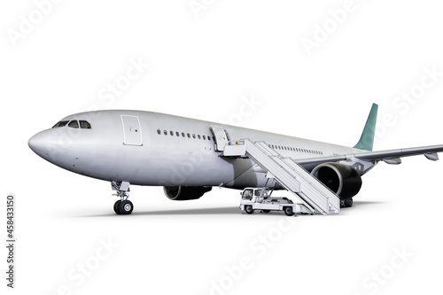 Wide body passenger airliner with air-stairs at the airport apron isolated on white background