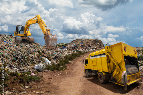 Huge garbage pile landfill, with machine working, plastic pollution crisis. global warming, ecosystem and healthy environment concepts photo