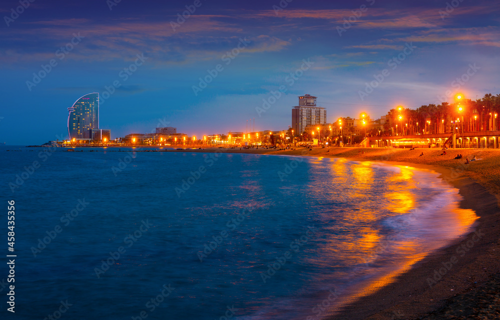 Evening view of the beach of Barceloneta - a lively quarter of the Old City of Barcelona, popular with locals and tourists