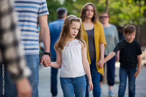 .Young dad walking by the hand with smiling girl on weekend © JackF