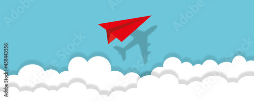 Valokuva Red paper plane with its shadow flying in the sky