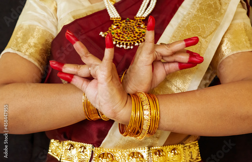 Female classical dancer hands on black background showing 