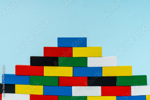 Stack of colorful wooden cuboid shape perfect for background.