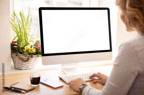 Woman working with desktop computer at home or office, screen mockup