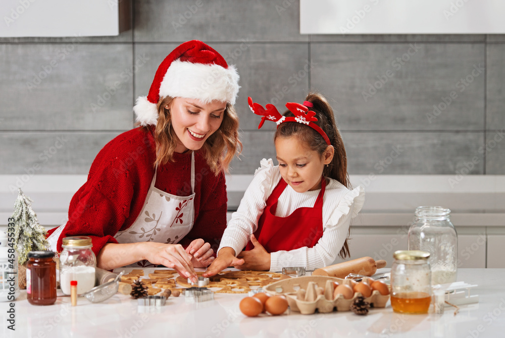 Mother and daughter making Christmas cookies in the kitchen Mother and daughter making Christmas cookies in the kitchen