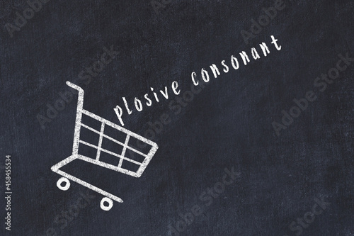 Chalk drawing of shopping cart and word plosive consonant on black chalboard. Concept of globalization and mass consuming photo