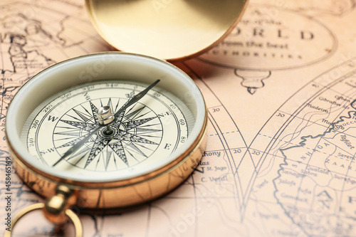 Old compass on vintage world map photo