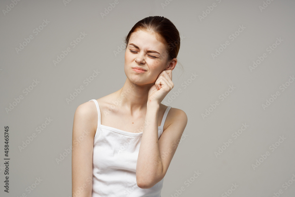 woman poor hearing disorders in white t-shirts isolated background woman poor hearing disorders in white t-shirts isolated background