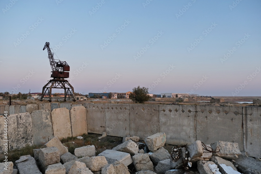 Aralsk, Kazakhstan - 10.04.2020 : The old metal structure of the destroyed port on the Aral Sea