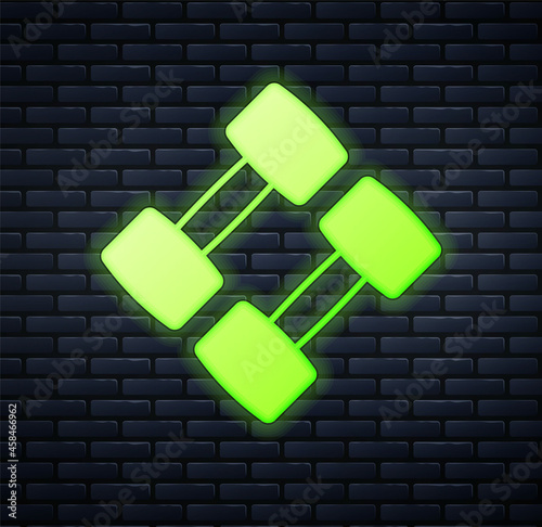 Glowing neon Dumbbell icon isolated on brick wall background. Muscle lifting, fitness barbell, sports equipment. Vector