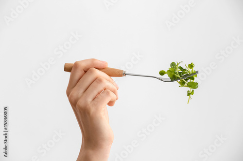 Female hand with fresh micr...